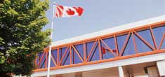 Canadian flag flying high above the CBSA building.